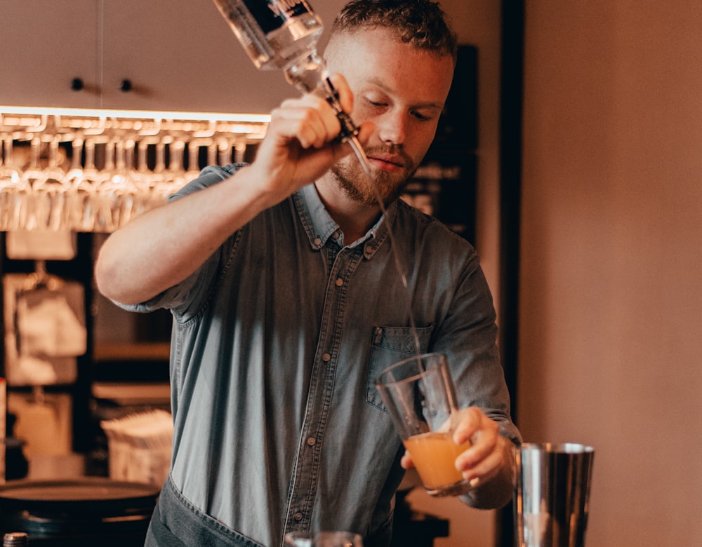 A bartender mixing a drink behind the bar