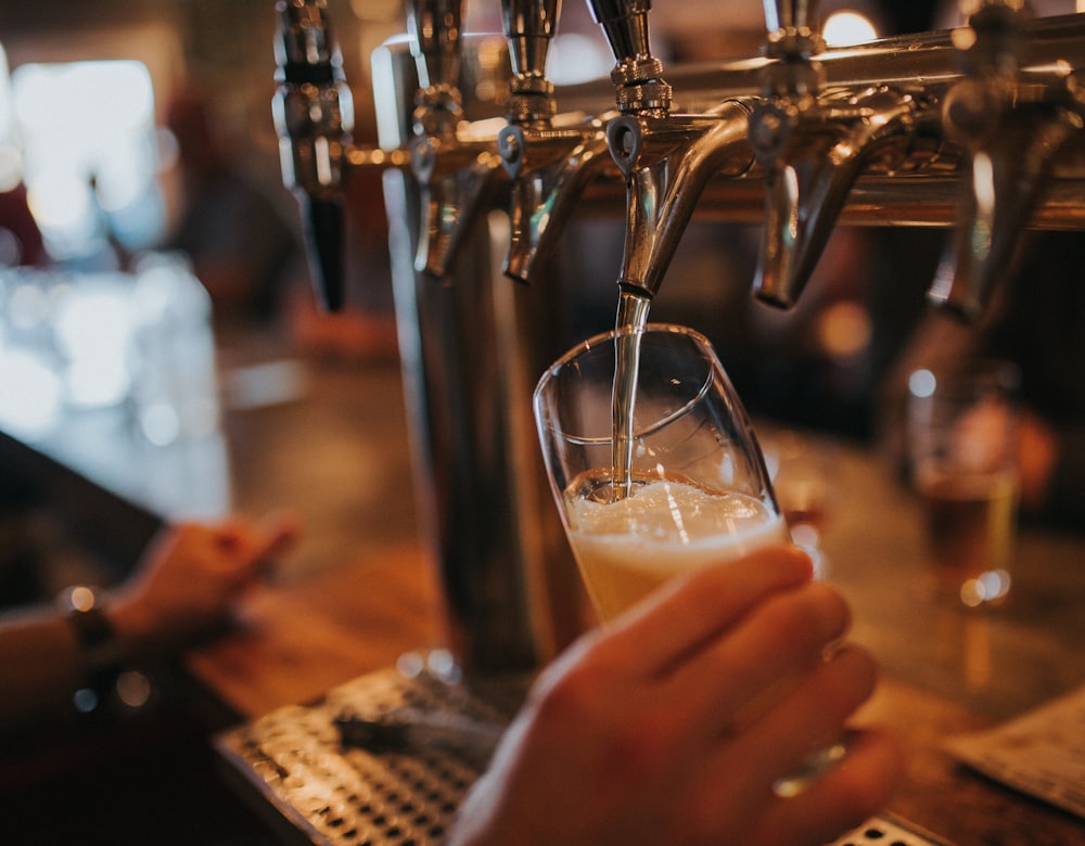 A glass of beer being pulled from the tap