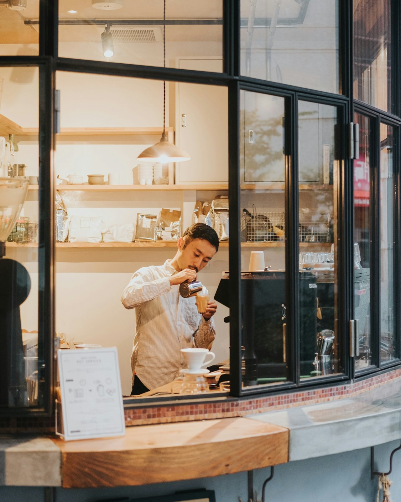 A barista working behind a café counter