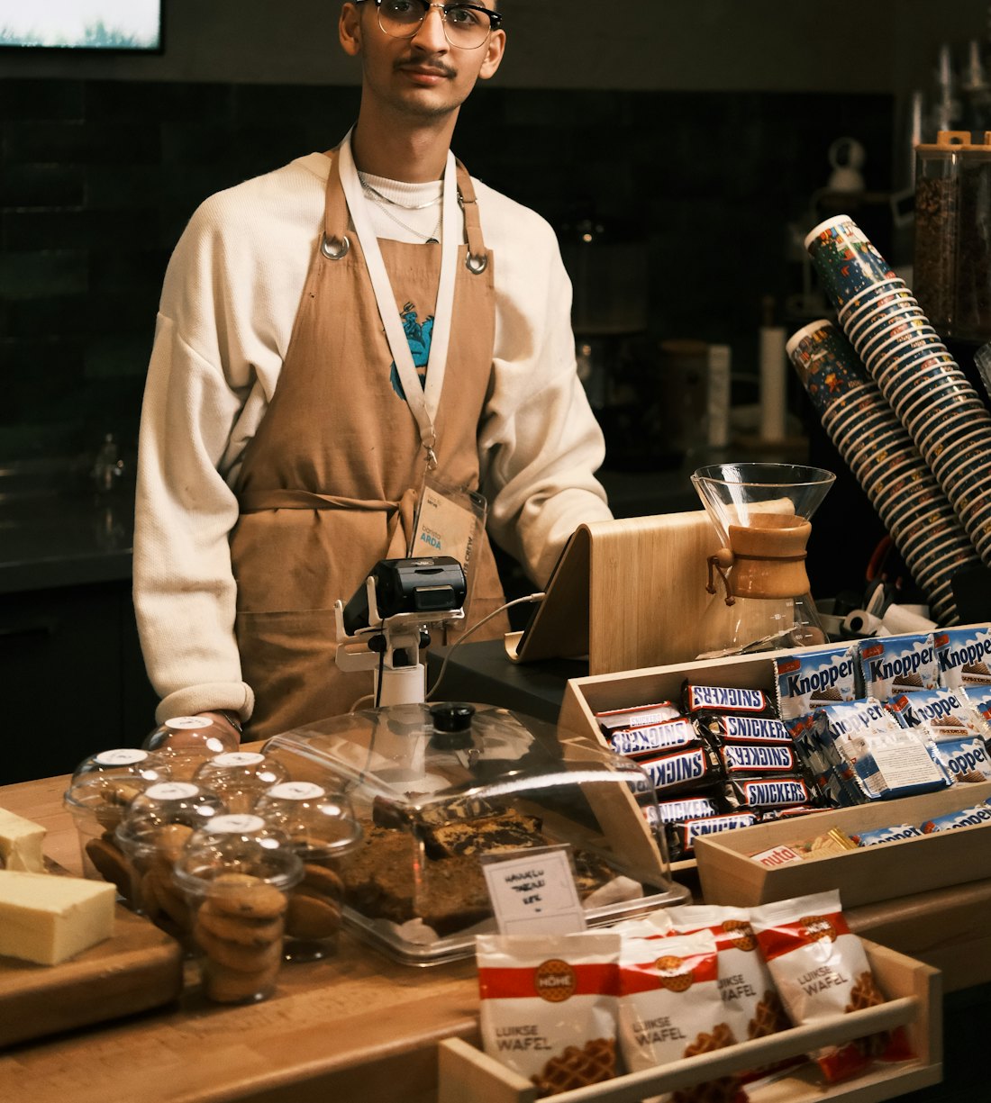 A barista serving a customer at a café counter