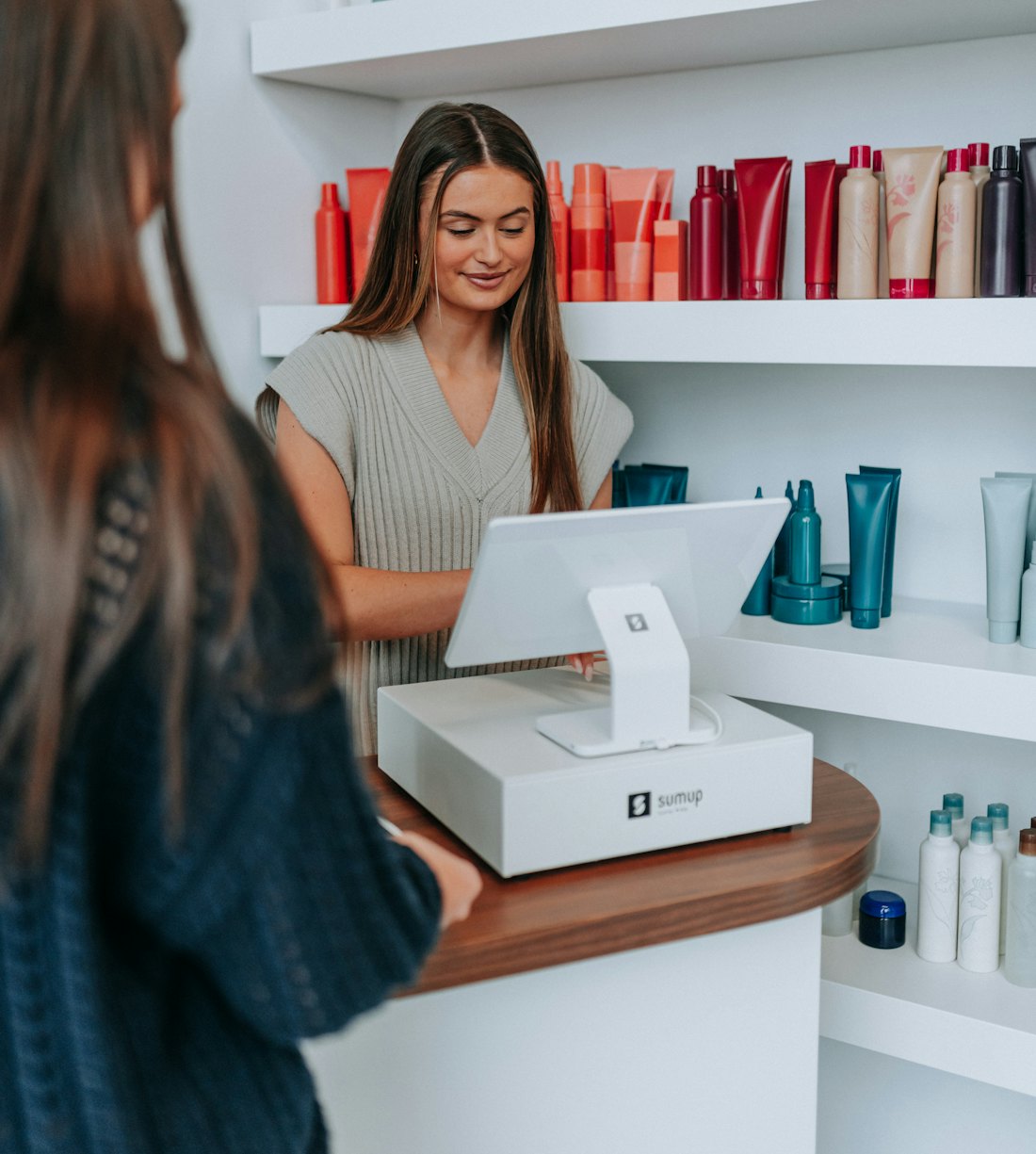 A shop assistant packing an order at the counter